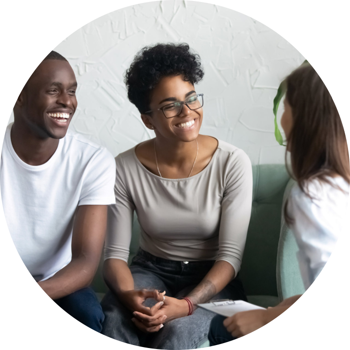 couple laughing together with their doctor