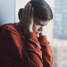 woman covering her ears with fear