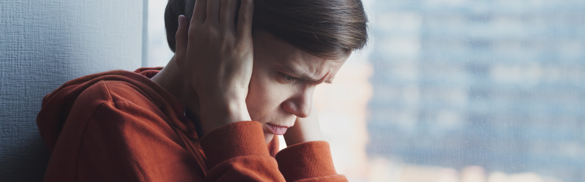 woman covering her ears with fear